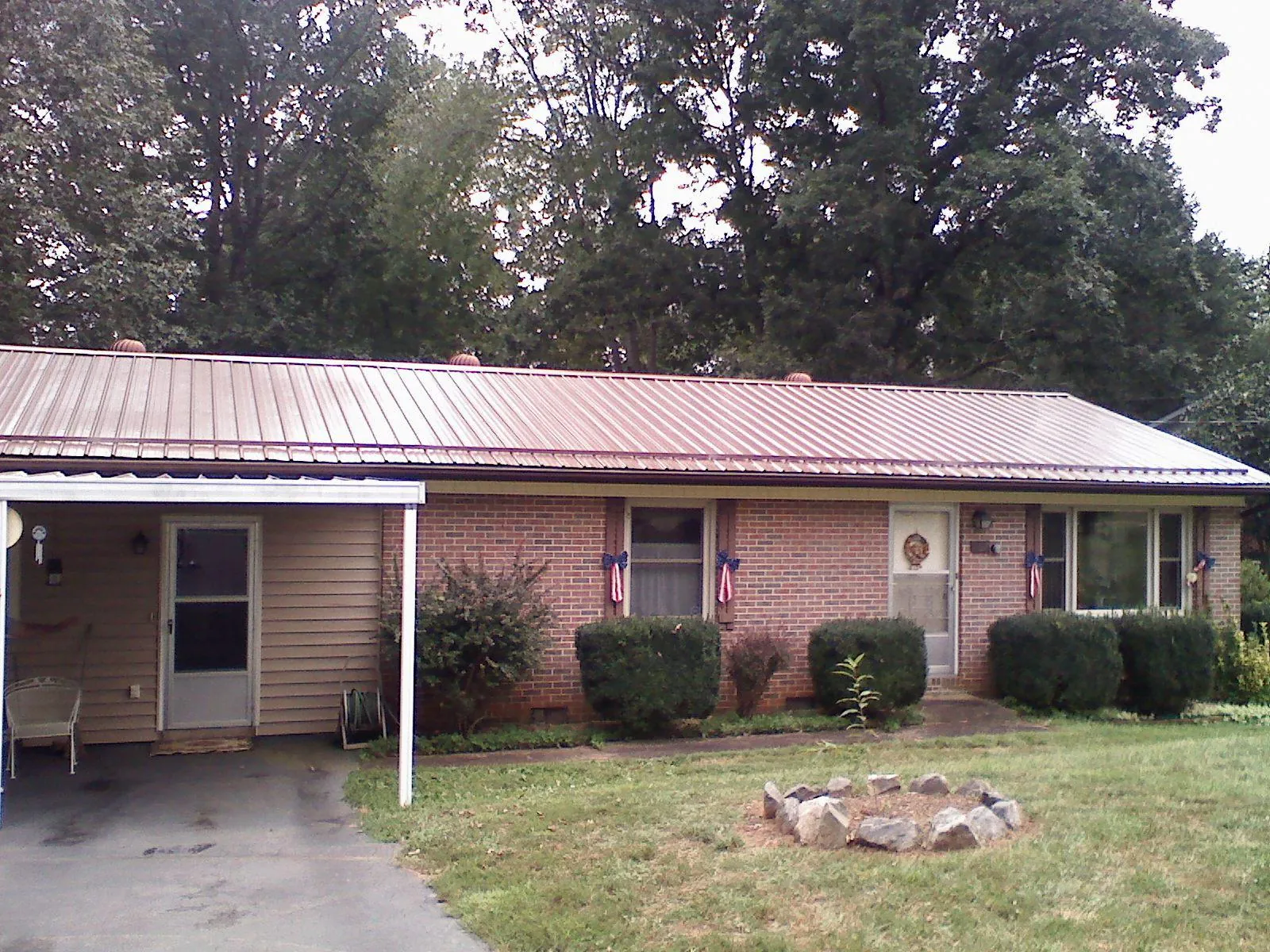 Bronze metal roof and carport on a brick ranch home in Pleasantville