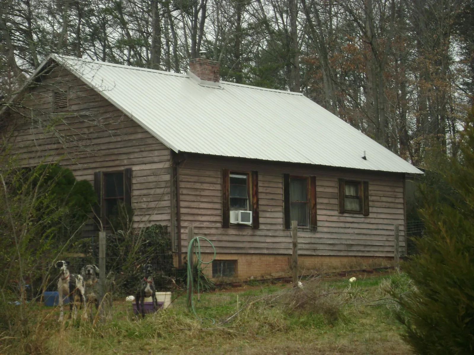 White metal roof on an old wood sided farmhouse, from a Metal Roof Installation job in Pleasantville
